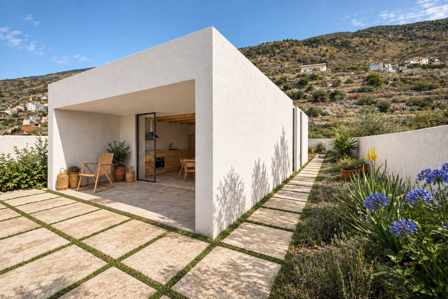 Volumen blanco de la vivienda abierto al jardín mediante una gran carpintería